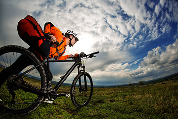 Image showing Young man is riding bicycle outside. Healthy Lifestyle.