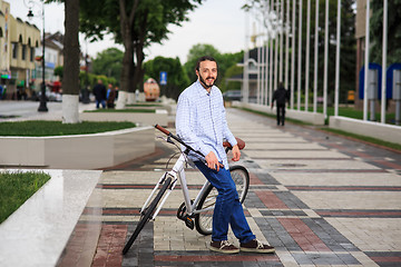 Image showing young hipster man with fixed gear bike on city street