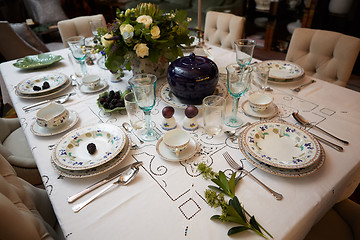 Image showing Beautifully decorated table set with flowers, candles, plates and serviettes for wedding or another event in the restaurant.