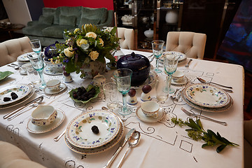 Image showing Beautifully decorated table set with flowers, candles, plates and serviettes for wedding or another event in the restaurant.