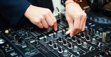 Image showing Dj mixes the track in the nightclub at party