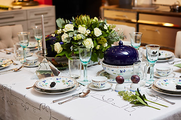 Image showing Beautifully decorated table set with flowers, candles, plates and serviettes for wedding or another event in the restaurant.