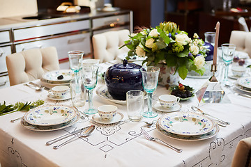 Image showing Beautifully decorated table set with flowers, candles, plates and serviettes for wedding or another event in the restaurant.