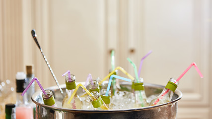 Image showing bottles with tasty drink in ice. Shallow dof