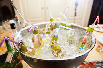 Image showing bottles with tasty drink in ice. Shallow dof