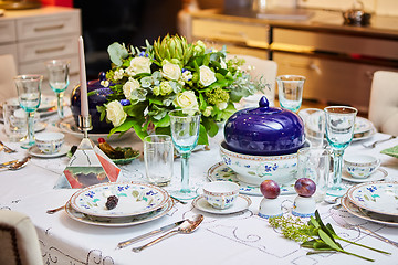 Image showing Beautifully decorated table set with flowers, candles, plates and serviettes for wedding or another event in the restaurant.