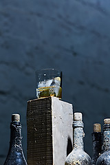 Image showing Glass of whiskey with ice on old wooden bar