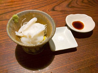 Image showing Slices of japanese octopus in a bowl with salt and soy sauce