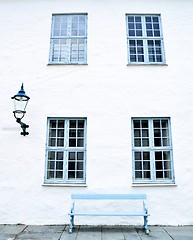 Image showing Blue windows, a blue bench and a streetlight