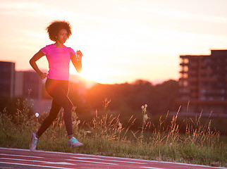 Image showing a young African American woman jogging outdoors