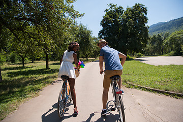 Image showing Young  couple having joyful bike ride in nature