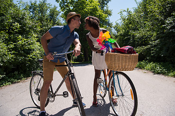 Image showing Young  couple having joyful bike ride in nature