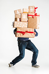 Image showing Gift boxes in the hands of young man