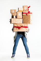 Image showing Gift boxes in the hands of young woman