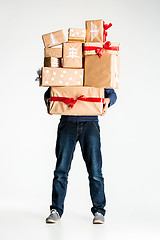 Image showing Gift boxes in the hands of young man