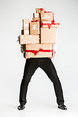 Image showing Gift boxes in the hands of young man