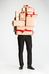 Image showing Gift boxes in the hands of young man