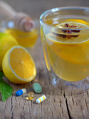 Image showing Hot lemon tea and pills