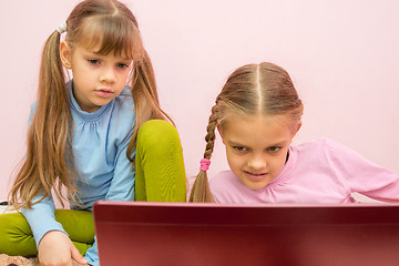 Image showing Girls look at the screen a bit tired of the view