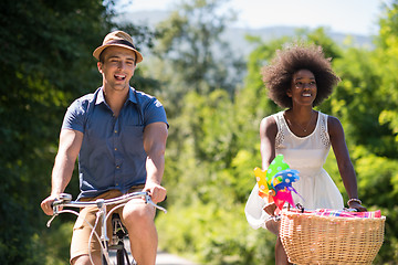 Image showing Young  couple having joyful bike ride in nature