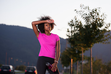 Image showing Portrait of a young african american woman running outdoors