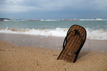 Image showing Beach slippers on a sandy beach