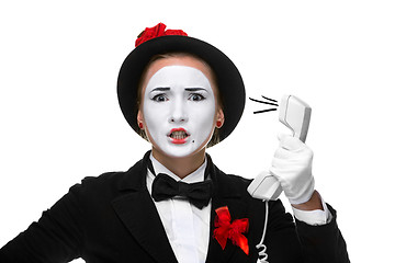 Image showing Woman in the image mime holding a handset. 