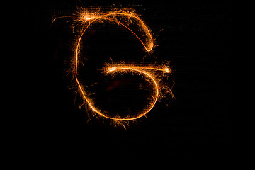 Image showing Letter G made of sparklers on black