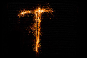 Image showing Letter T made of sparklers on black