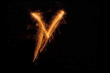 Image showing Letter V made of sparklers on black