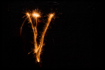 Image showing Letter V made of sparklers on black