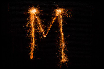 Image showing Letter M made of sparklers on black