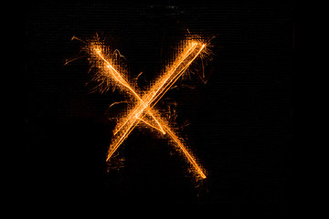 Image showing Letter X made of sparklers on black