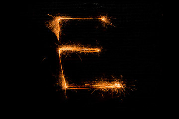Image showing Letter E made of sparklers on black