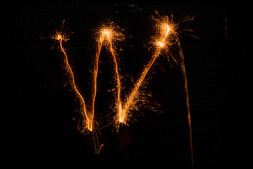 Image showing Letter W made of sparklers on black