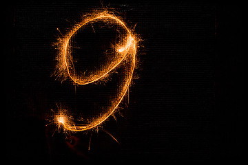 Image showing Number 9 made of sparklers on black