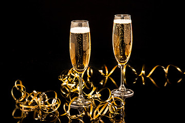 Image showing Glasses with champagne against holiday lights