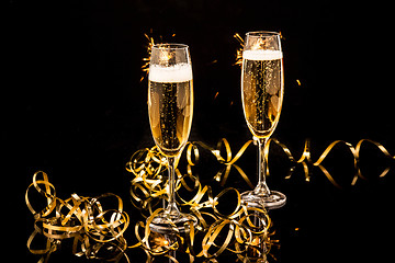 Image showing Glasses with champagne against holiday lights