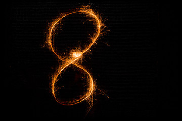 Image showing Number 8 made of sparklers on black