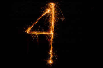 Image showing Number 4 made of sparklers on black