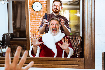 Image showing Santa claus shaving his personal barber