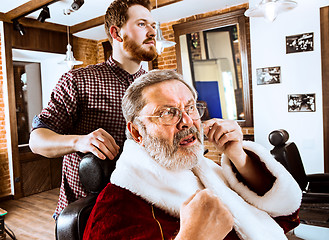 Image showing Santa claus shaving his personal barber