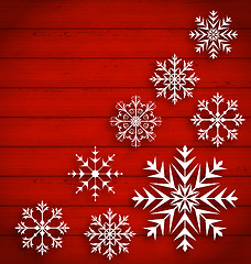 Image showing Set Abstract Different Snowflakes on Wooden Texture