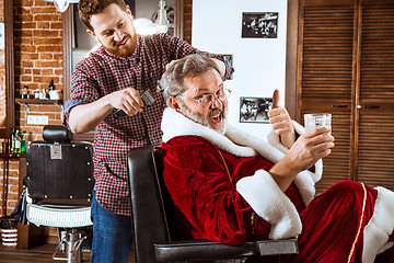Image showing Santa claus shaving his personal barber