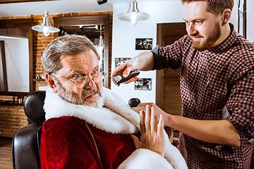 Image showing Santa claus shaving his personal barber