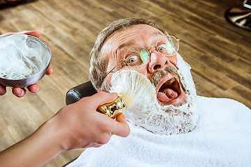 Image showing The senior man visiting hairstylist in barber shop.