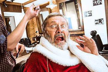 Image showing Santa claus shaving his personal barber