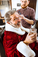 Image showing Santa claus shaving his personal barber