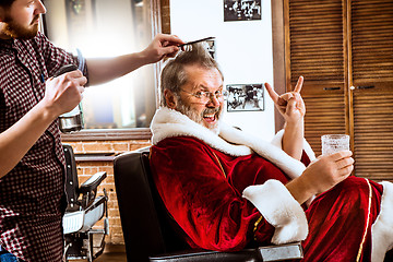 Image showing Santa claus shaving his personal barber