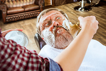 Image showing The senior man visiting hairstylist in barber shop.